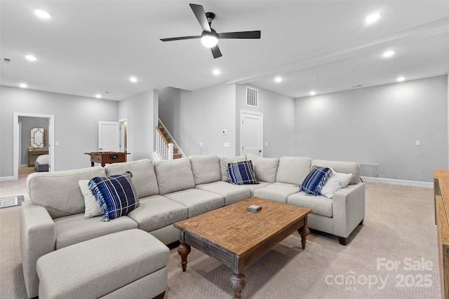 living area with stairs, visible vents, light colored carpet, and recessed lighting