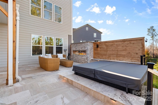 view of patio featuring an outdoor hangout area and a covered hot tub