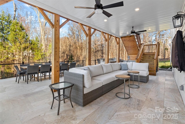 view of patio with a ceiling fan, outdoor dining space, stairs, and an outdoor hangout area