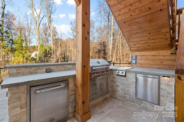 view of patio / terrace featuring exterior kitchen and area for grilling