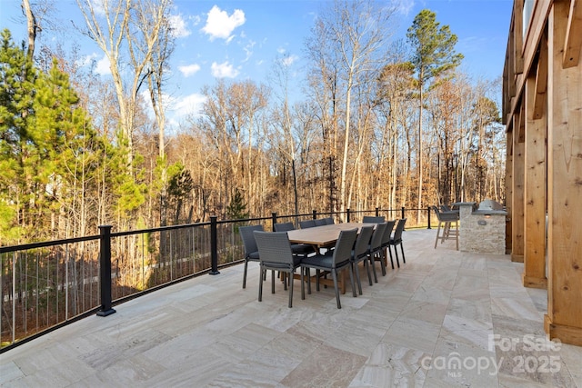 view of patio / terrace featuring exterior kitchen and outdoor dining area