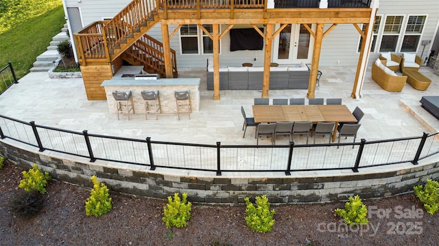 view of patio with stairway, outdoor dining space, outdoor dry bar, and an outdoor hangout area