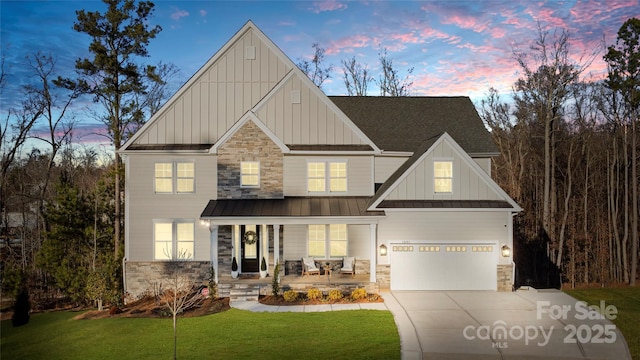 view of front of property featuring stone siding, a porch, board and batten siding, and a standing seam roof