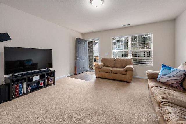 living room with light carpet, baseboards, and visible vents