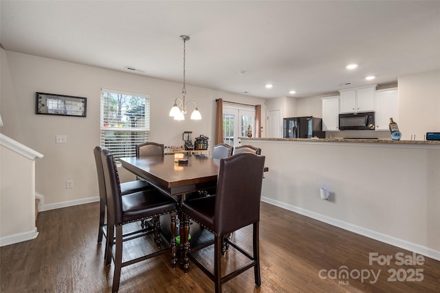 dining room with a healthy amount of sunlight, dark wood-style floors, and baseboards