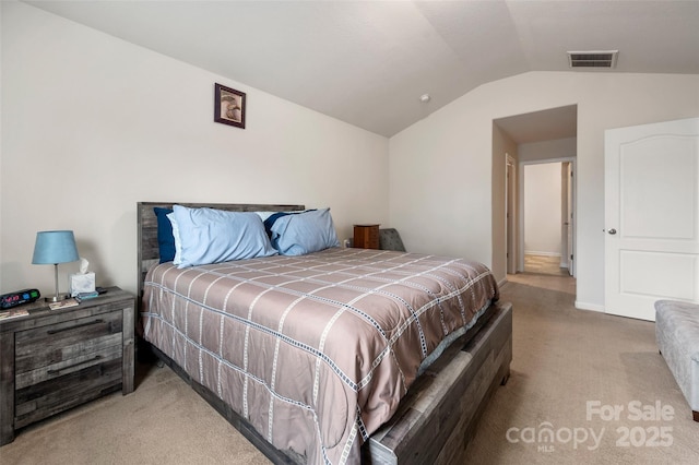 bedroom with vaulted ceiling, light carpet, visible vents, and baseboards