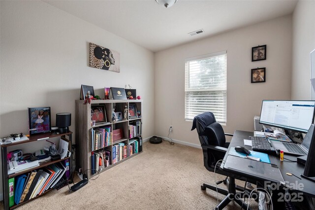 office area with baseboards, visible vents, and carpet flooring