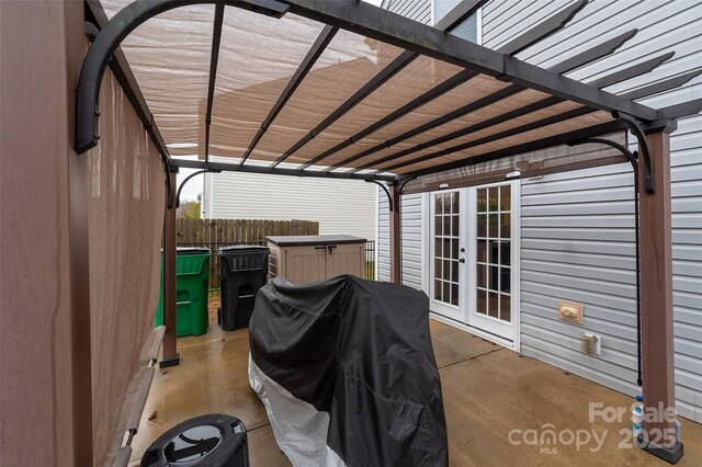 view of patio with fence, grilling area, a pergola, and french doors