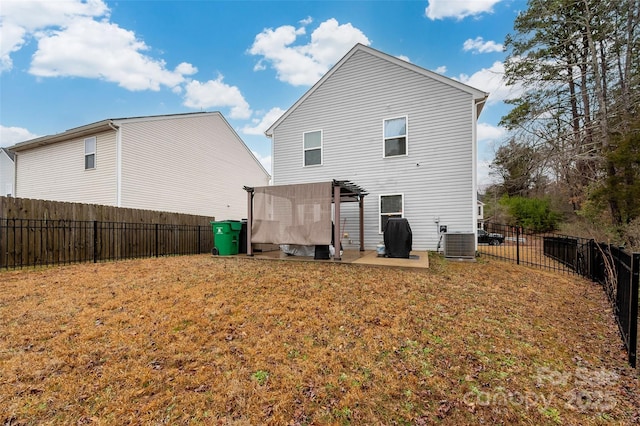 back of house with a fenced backyard, cooling unit, and a lawn