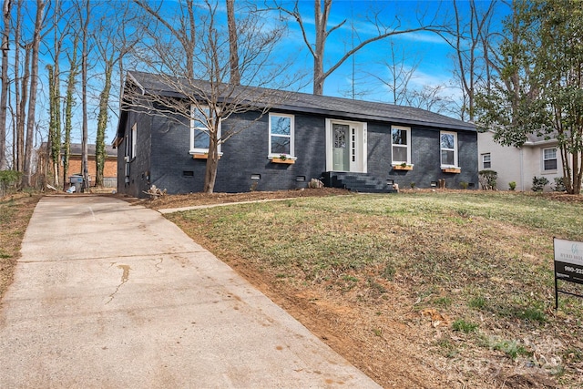 single story home featuring brick siding, a shingled roof, concrete driveway, crawl space, and a front lawn