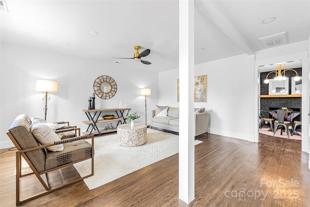 5825 Ruth Dr, Charlotte, NC 28215 - living room featuring ceiling fan, wood finished floors, visible vents, and baseboards