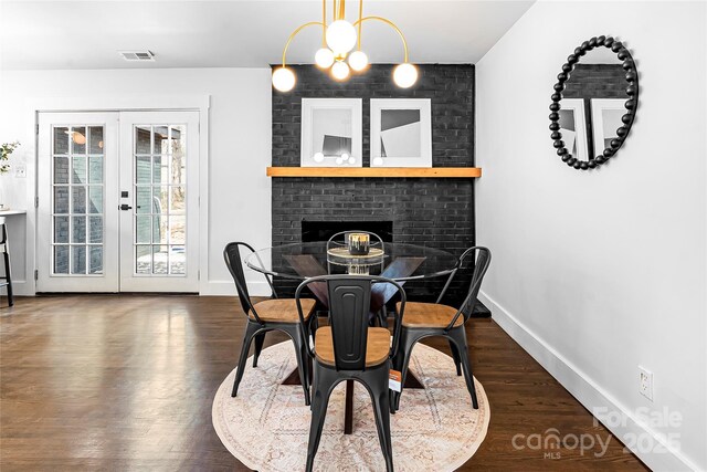 5825 Ruth Dr, Charlotte, NC 28215 - dining space with a notable chandelier, wood finished floors, visible vents, baseboards, and french doors