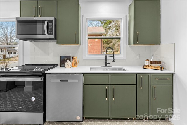 5825 Ruth Dr, Charlotte, NC 28215 - kitchen with green cabinets, light countertops, appliances with stainless steel finishes, and a sink