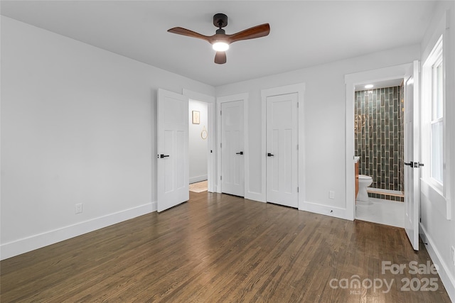 5825 Ruth Dr, Charlotte, NC 28215 - unfurnished bedroom with connected bathroom, two closets, baseboards, and wood finished floors