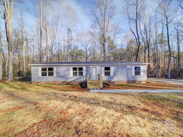 manufactured / mobile home featuring crawl space and a front lawn