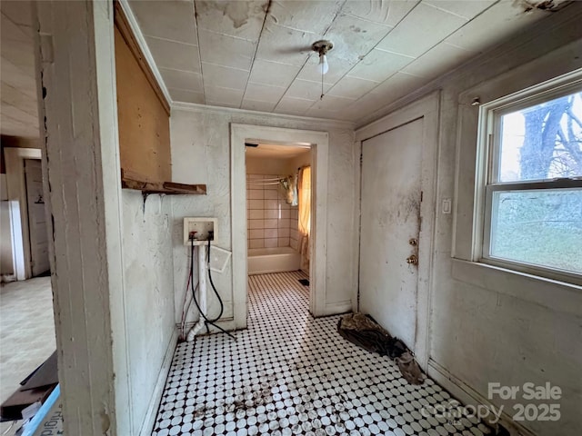 interior space featuring laundry area, ornamental molding, washer hookup, and light floors