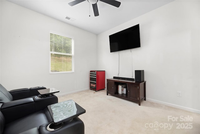 living room with light colored carpet, ceiling fan, visible vents, and baseboards