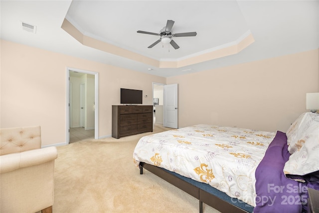 carpeted bedroom with baseboards, visible vents, a tray ceiling, and ornamental molding