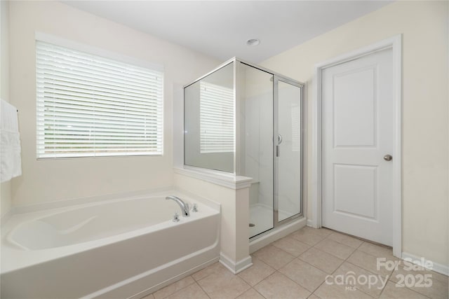 bathroom featuring a shower stall, tile patterned floors, and a bath