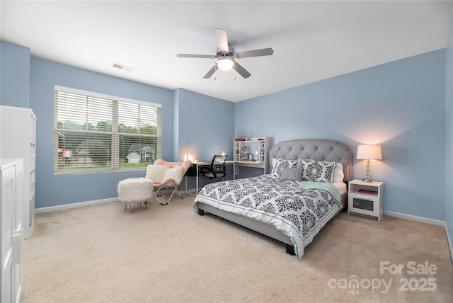 bedroom featuring baseboards, visible vents, light carpet, and ceiling fan