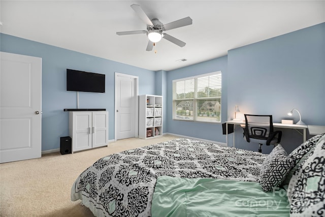 carpeted bedroom featuring baseboards, ceiling fan, and visible vents