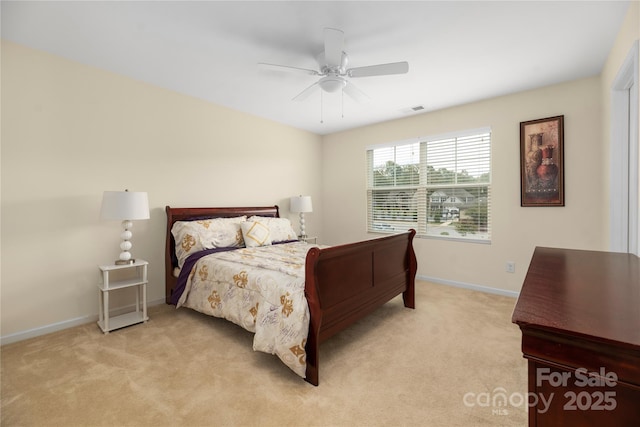 bedroom featuring ceiling fan, visible vents, baseboards, and light colored carpet