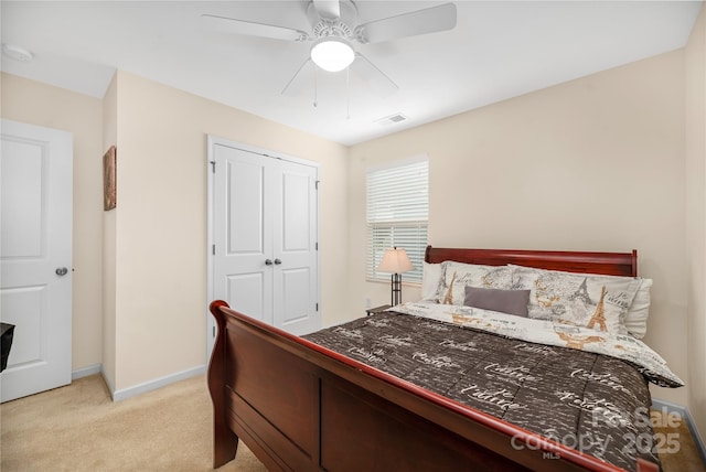 bedroom with light carpet, baseboards, visible vents, ceiling fan, and a closet