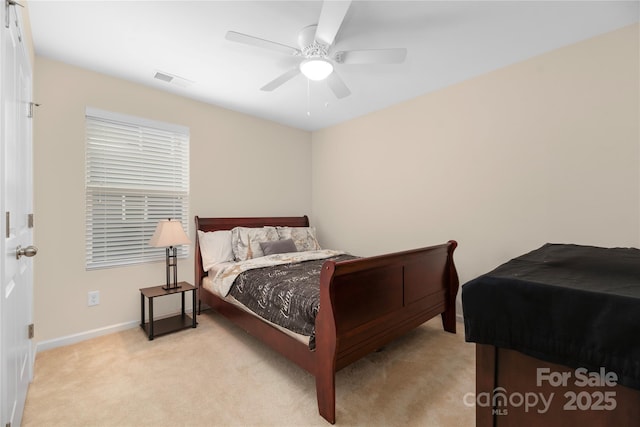 bedroom featuring baseboards, ceiling fan, visible vents, and light carpet