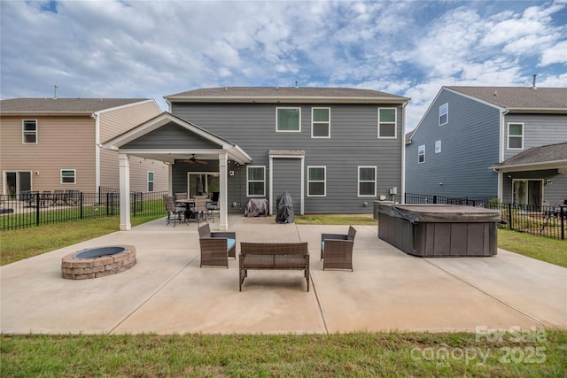 rear view of house featuring a ceiling fan, a patio area, a hot tub, an outdoor living space with a fire pit, and fence private yard