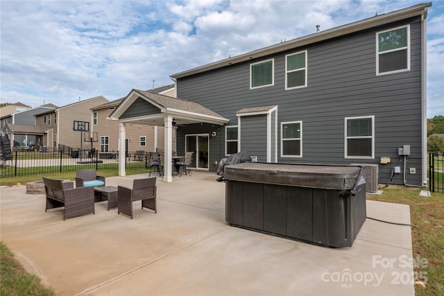 back of house with fence, central AC, a hot tub, and a patio