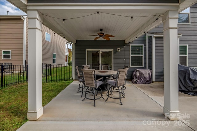 view of patio / terrace featuring fence, outdoor dining space, and a ceiling fan