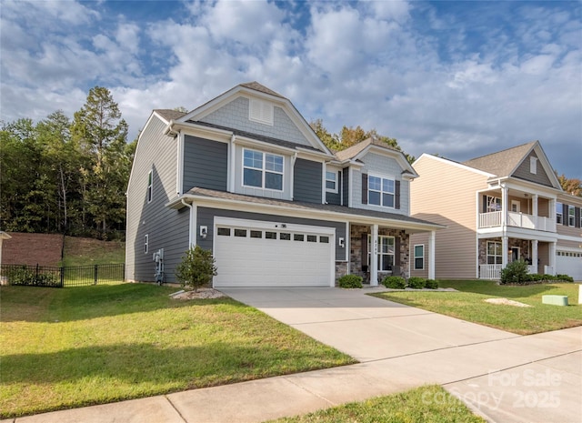 view of front facade with a garage, a front yard, concrete driveway, and fence