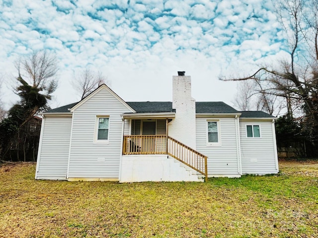 rear view of property with stairway, a lawn, and a chimney