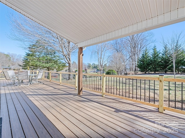 wooden terrace with outdoor dining area