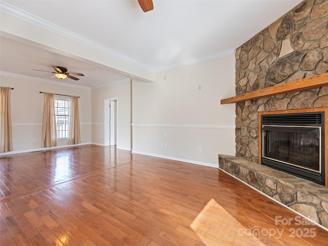 unfurnished living room with ceiling fan, a fireplace, baseboards, and wood finished floors