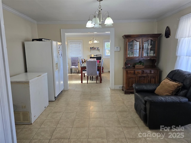 interior space featuring ornamental molding, decorative light fixtures, refrigerator, an inviting chandelier, and white fridge with ice dispenser