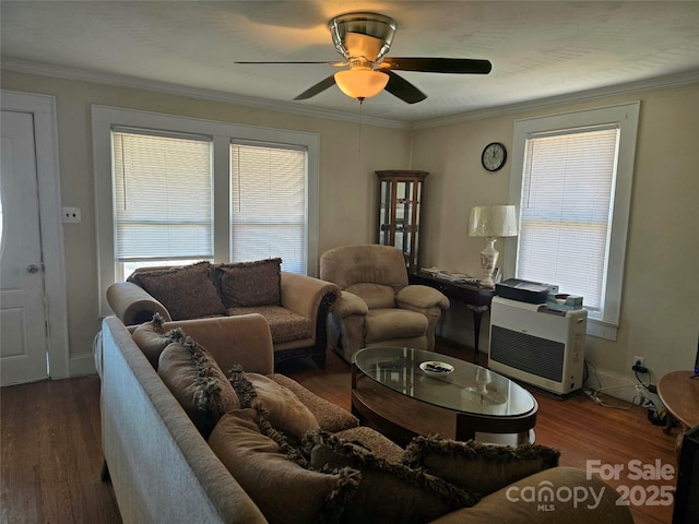 living area with baseboards, ornamental molding, dark wood finished floors, and a ceiling fan