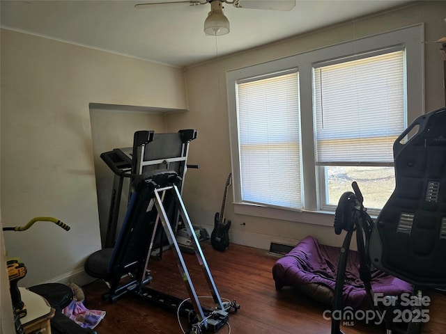 workout area with ceiling fan, dark wood finished floors, and baseboards