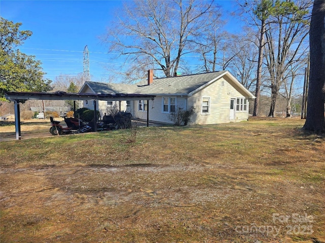 view of front of home with a chimney and a front yard