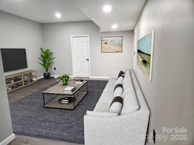 living area with baseboards, wood finished floors, and recessed lighting