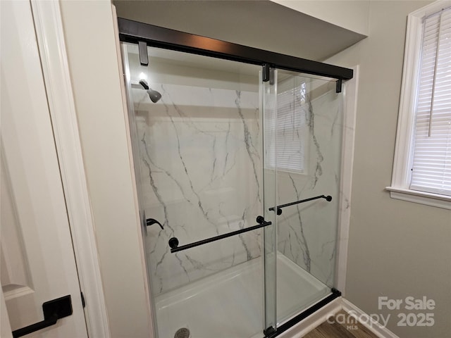 full bath featuring a marble finish shower