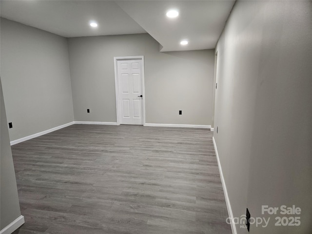 basement with baseboards, wood finished floors, and recessed lighting