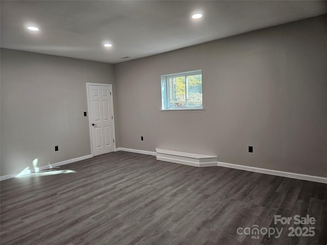 spare room with recessed lighting, dark wood finished floors, and baseboards