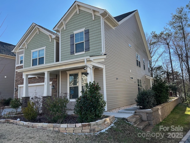 craftsman-style house with stone siding and a porch