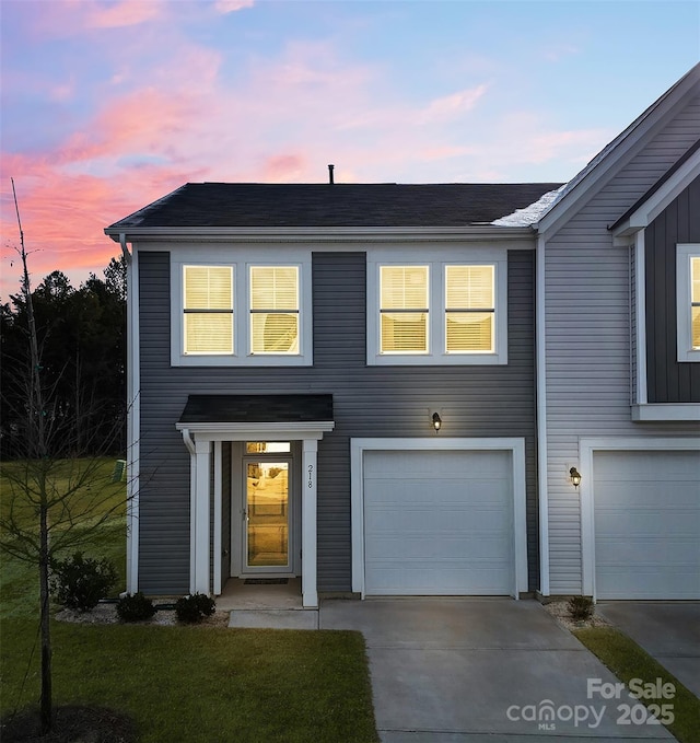 view of front facade with a garage and concrete driveway