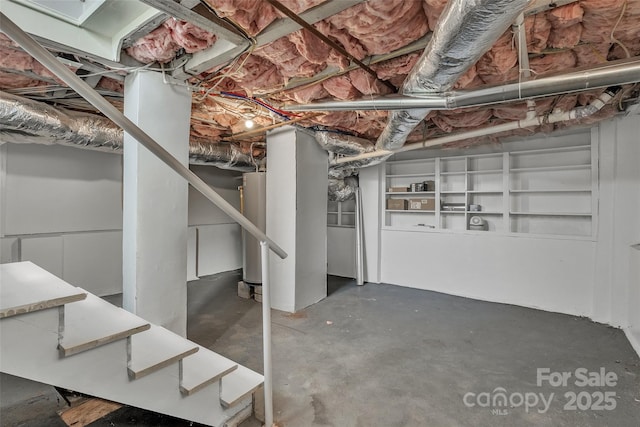 unfinished basement featuring water heater