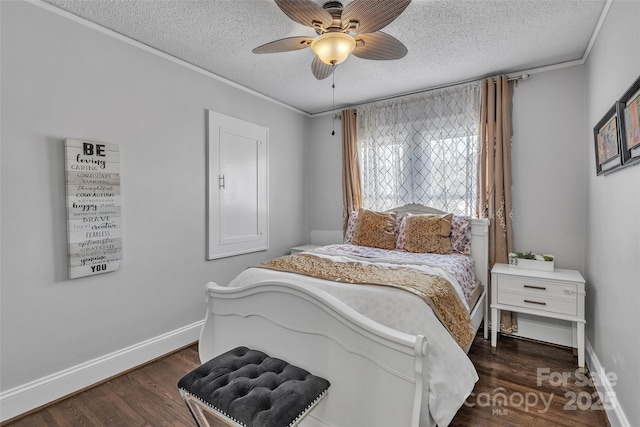 bedroom with crown molding, a textured ceiling, dark wood-type flooring, and baseboards