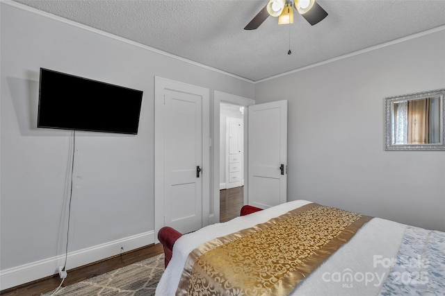 bedroom with a ceiling fan, crown molding, wood finished floors, and a textured ceiling