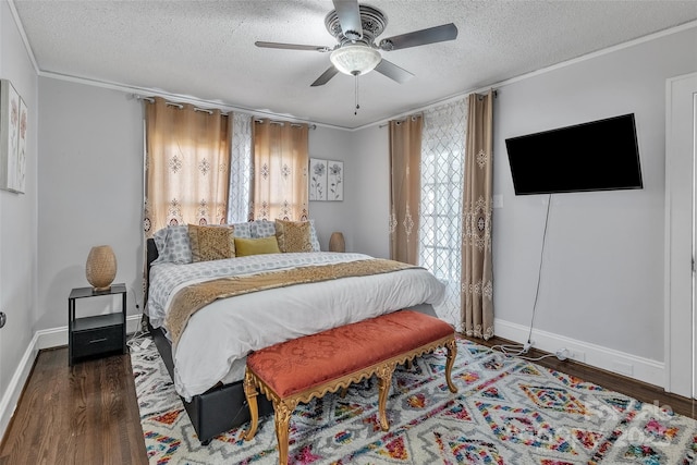 bedroom with ceiling fan, baseboards, ornamental molding, wood finished floors, and a textured ceiling