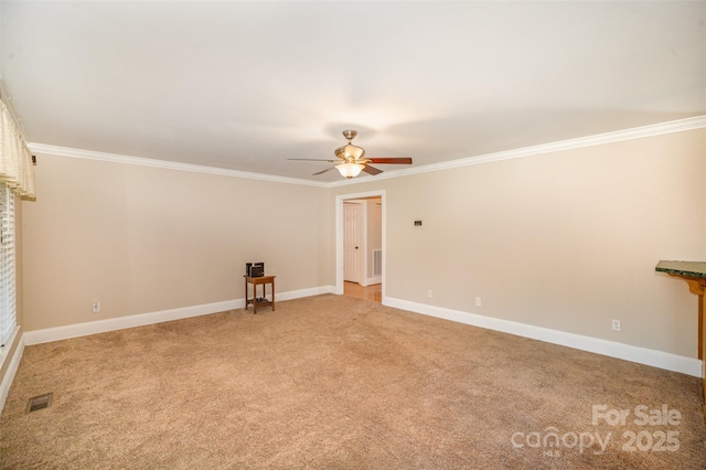 spare room with visible vents, ornamental molding, light carpet, ceiling fan, and baseboards